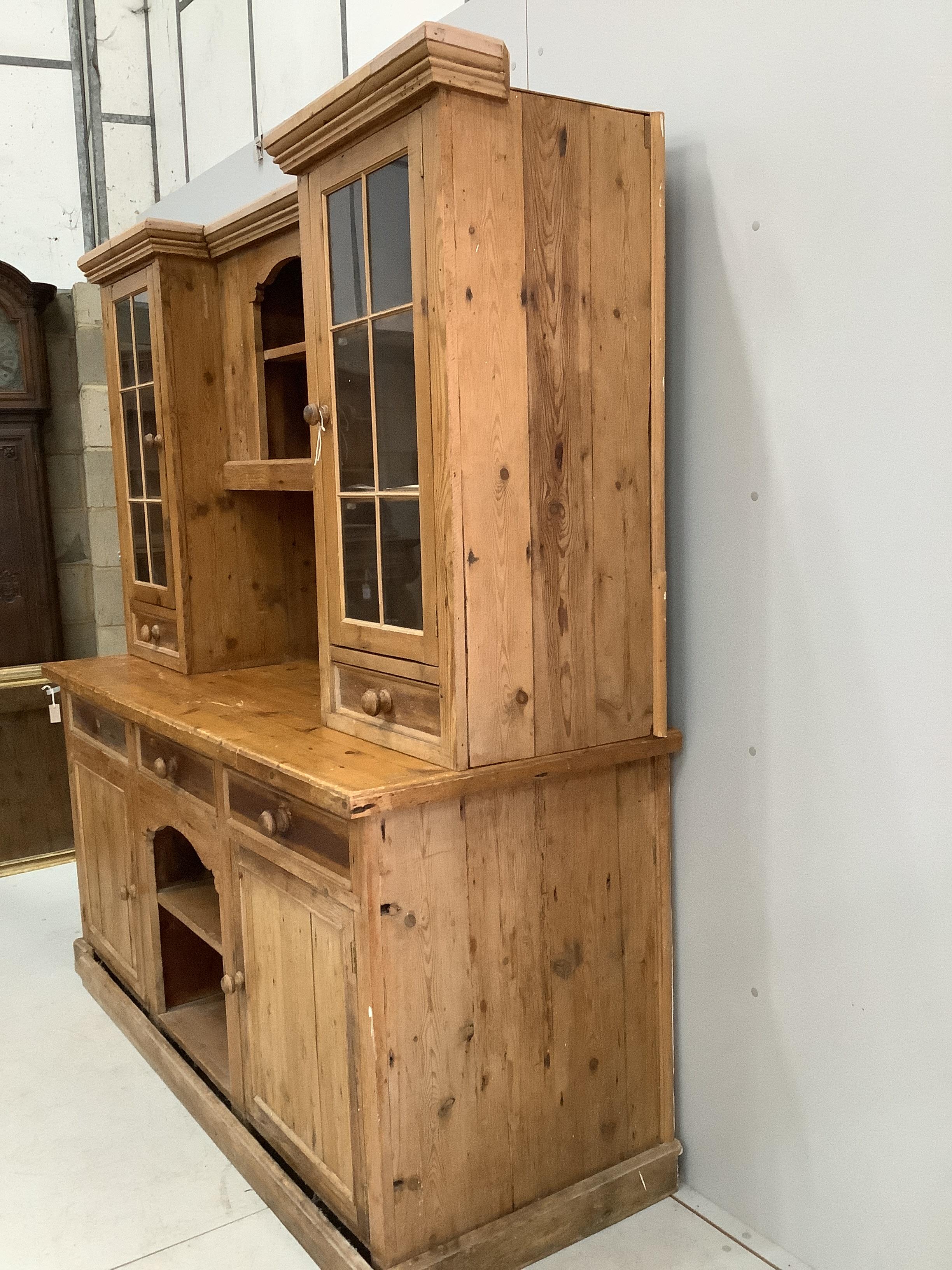A Victorian style pine dresser with glazed cupboards, width 186cm, depth 68cm, height 203cm
